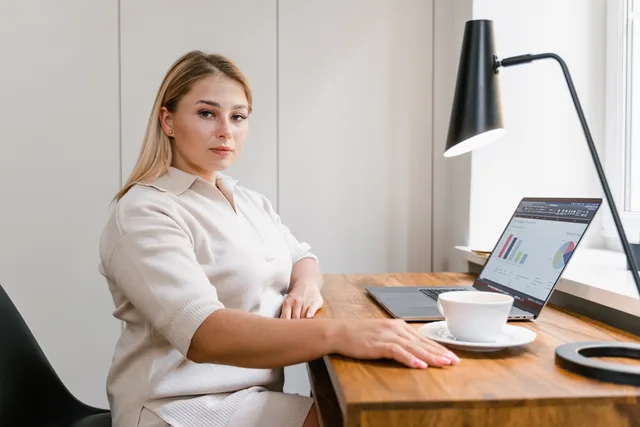 Confident woman working on a laptop in a modern office with data charts displayed. Women founder funding in 2027: Start Up Loans, the Rose Review, the Investing in Women Code and three scenarios