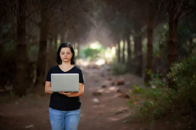 woman, work, laptop, computer, electronic, freelance, nature, forest. A women founder funding strategy that funds a milestone, not a vague ambition